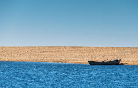 Solo Rowboat Moored on Sandy Beach, copyspace for your ideaの写真素材