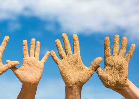 Woman and Man Shows his Open Hands Covered with Beach Sand, summer vacations