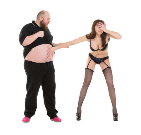 Almost Naked Woman Appalled and Surprised by the Size Man Stomach, isolated on white backgroundの写真素材