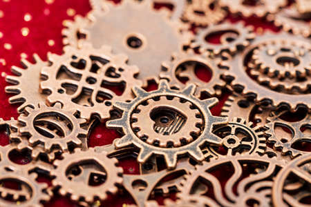Vintage Mechanical Cogwheel Gears Wheels, close up on red backgroundの写真素材