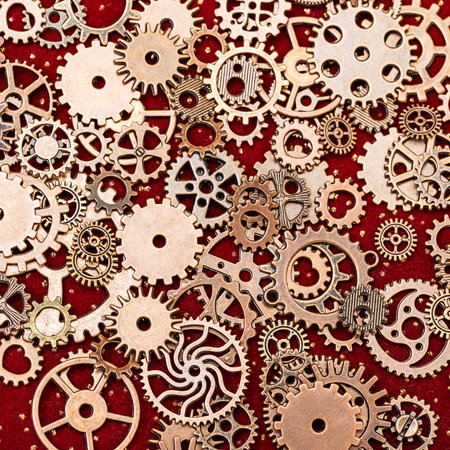 Vintage Mechanical Cogwheel Gears Wheels, close up on red backgroundの写真素材