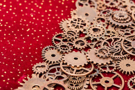 Vintage Mechanical Cogwheel Gears Wheels, close up on red backgroundの写真素材