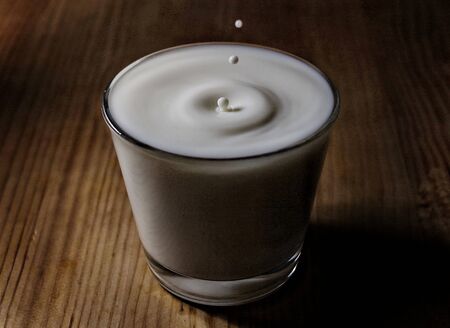 Small drops on glass of milkの写真素材