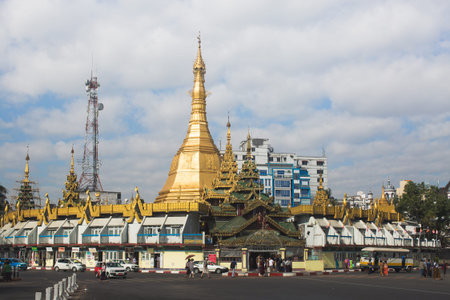 YANGON, MYANMAR - JAN 12, 2015: The famous golden Sule pagoda surrounded by market, view from the road.のeditorial素材
