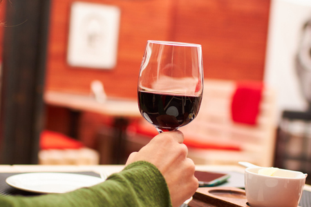glass of red wine in cafeの写真素材
