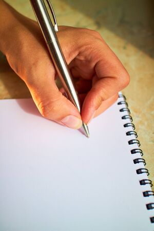 write with a pen in a notebookの写真素材