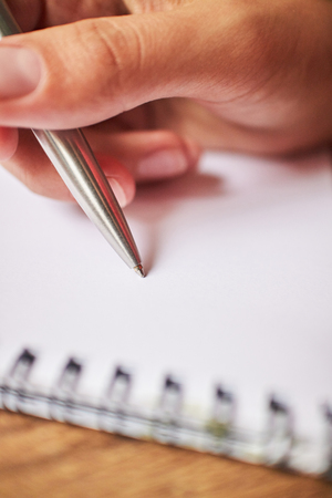write with a pen in a notebookの写真素材