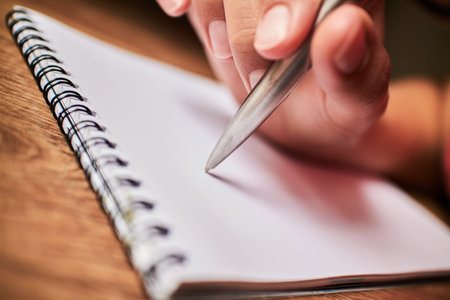 write with a pen in a notebook 