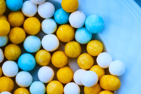 sugar candy balls yellow, white, purple