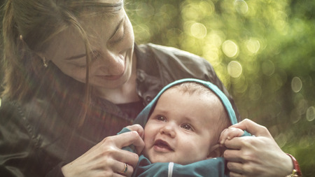 mother with smiling baby on sportswearの写真素材