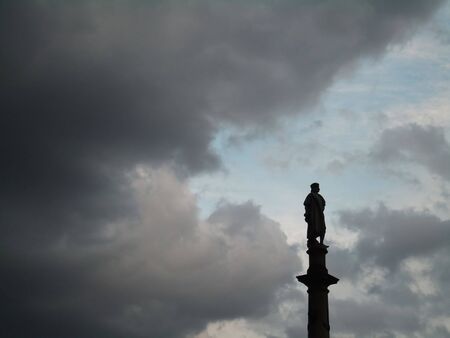Statue of Columbus against a dramatic skyの写真素材