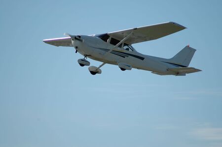 Light plane in flight, Palo Alto Airport, Californiaの写真素材