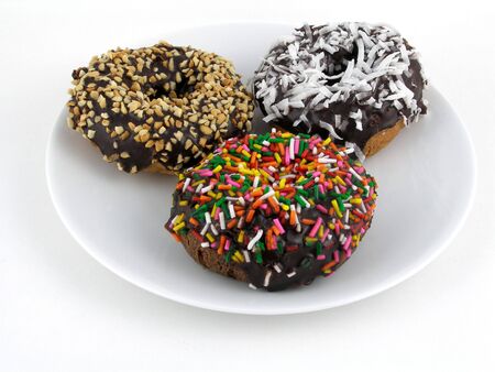 A trio of frosted chocolate doughnutsの写真素材