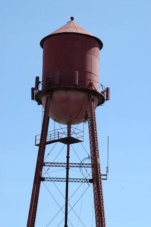 Worker climbing water tower, Morgan Hill, Californiaの写真素材