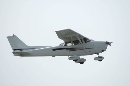 Light plane in flight, Palo Alto Airport, Californiaの写真素材