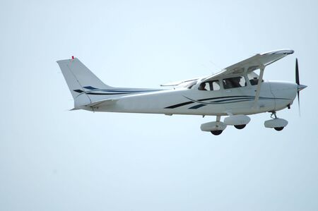 Light plane in flight, Palo Alto Airport, Californiaの写真素材