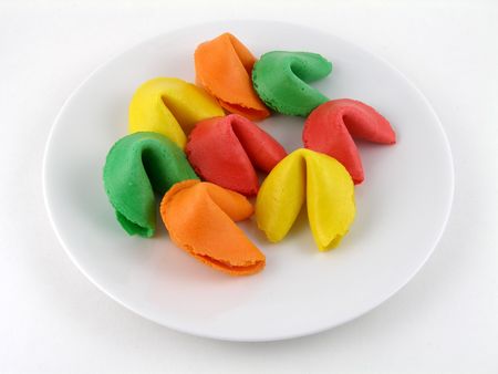 A plate of rainbow colored fortune cookiesの写真素材