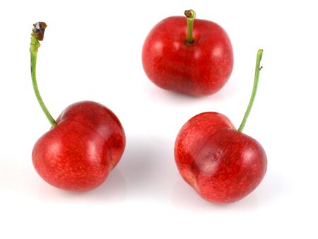 Three cherries with their stems pointed up - shallow DOFの写真素材