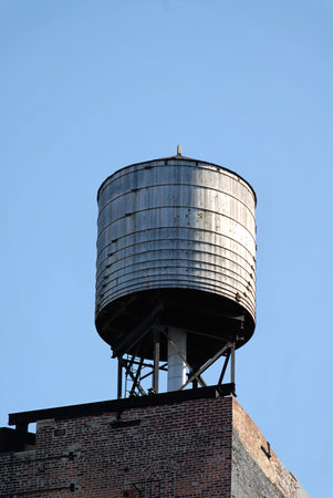 Water tower atop an old building in New York's Soho neighborhoodの写真素材