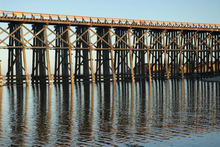 Railroad trestle reflected in the water, Fort Bragg, Californiaの写真素材
