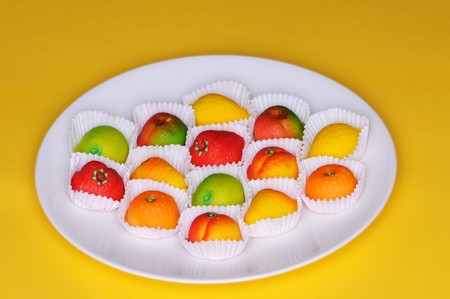 A collection of marzipan fruits on a plateの写真素材