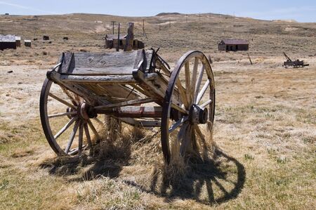 Old wagon in dry grass, Bodie State Historic Park, Californiaの写真素材