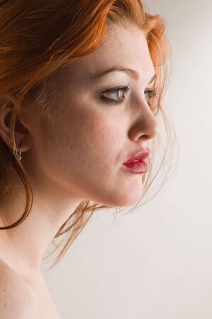 Portrait of a beautiful young redheaded womanの写真素材