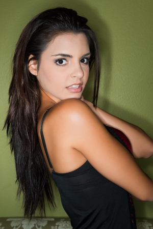 Beautiful petite brunette in red and black lingerieの写真素材