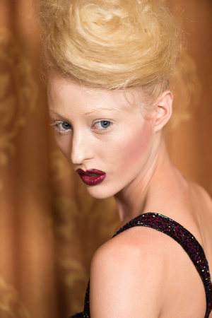 Slender pale blonde in a purple gown
