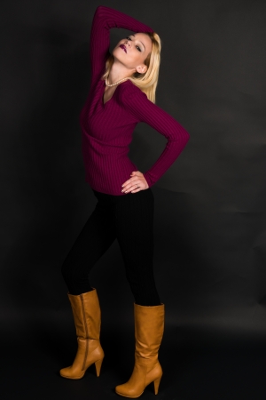 Pretty blonde woman in a purple sweaterの写真素材