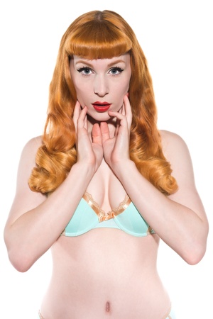 Beautiful young redhead in vintage blue and gold lingerieの写真素材