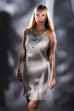 Pretty young Russian blonde in a white sleeveless topの写真素材