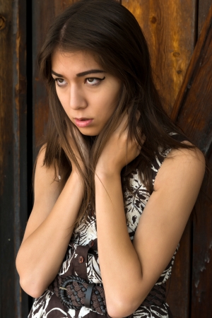 Beautiful petite Eurasian woman in a print dressの写真素材