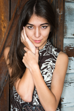 Beautiful petite Eurasian woman in a print dressの写真素材
