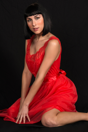 Beautiful slender brunette in a red dressの写真素材