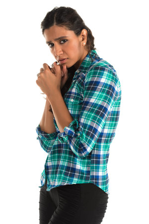 Beautiful tall Indian woman in a plaid shirtの写真素材