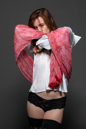 Pretty pale redhead in a white blouse and black pantiesの写真素材
