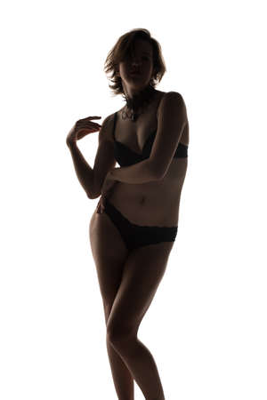 Pretty young brunette dressed in black lingerieの写真素材