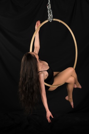 Petite young brunette on an aerial ringの写真素材
