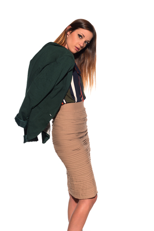 Tall slim brunette dressed in green and tanの写真素材