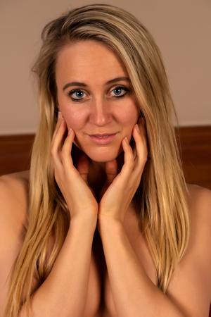 Closeup on the face of a beautiful slender tanned blondeの写真素材