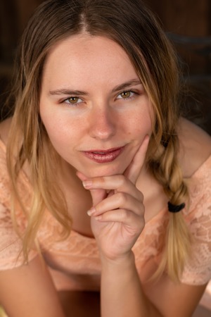 Pretty petite brunette in a peach dressの写真素材