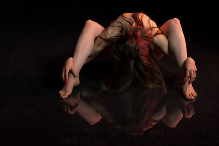 Petite athletic brunette nude on blackの写真素材