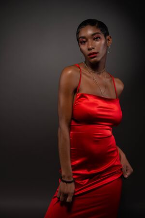 Slender young African American woman in a tight red dressの写真素材