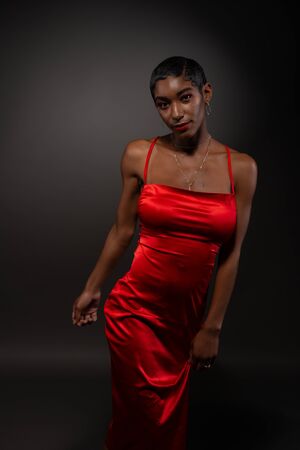 Slender young African American woman in a tight red dressの写真素材