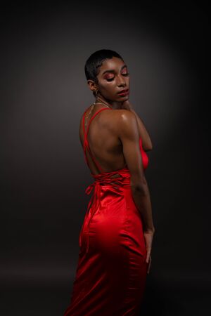 Slender young African American woman in a tight red dressの写真素材