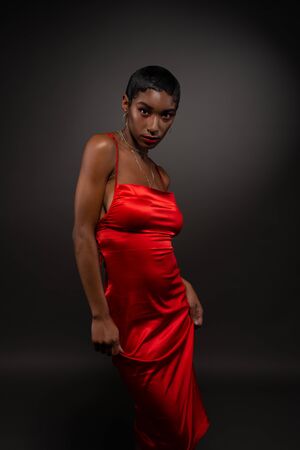 Slender young African American woman in a tight red dressの写真素材