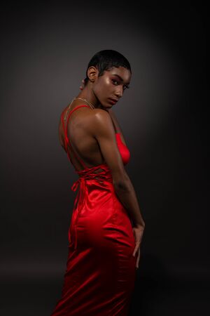 Slender young African American woman in a tight red dressの写真素材