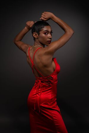 Slender young African American woman in a tight red dressの写真素材