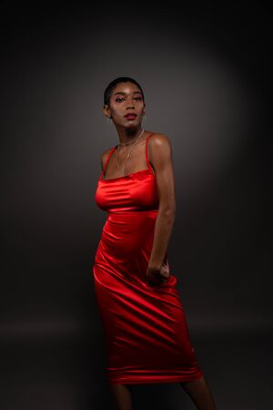 Slender young African American woman in a tight red dressの写真素材